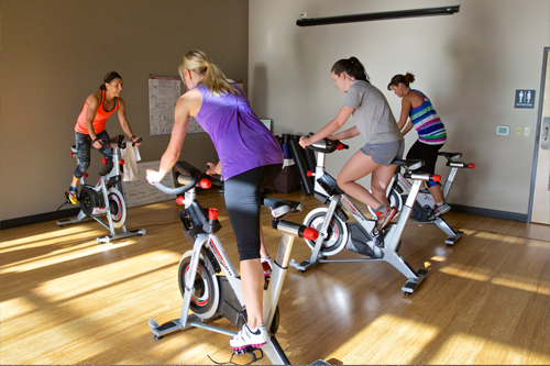 people in group cycling class