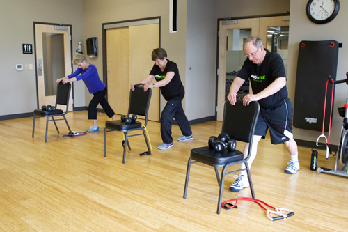 people performing exercises in senior fit class