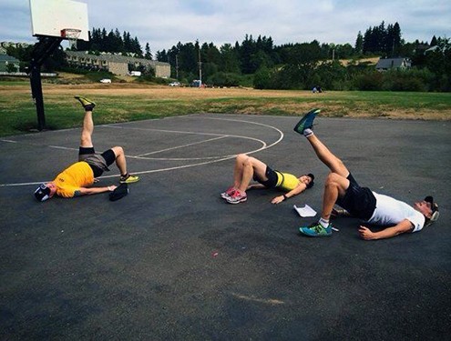 athletes exercising on outdoor basketball court