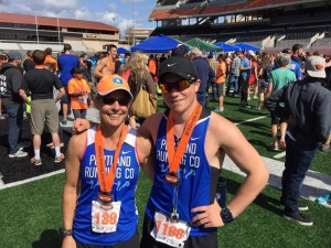 female and male athlete standing with arm around each other at half marathon event
