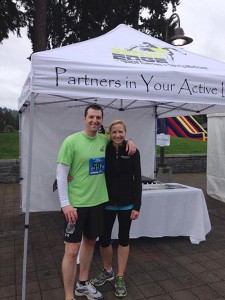 male and female athlete standing with arm around each other at outdoor event