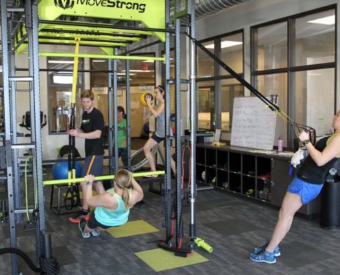 people performing exercises in gym room