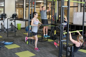 people performing exercise in gym room