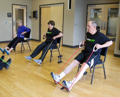 people performing seated rows with exercise bands
