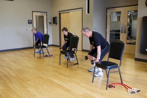 people performing squats with dumbbells