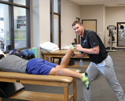 Physical therapist working with client on stretching table